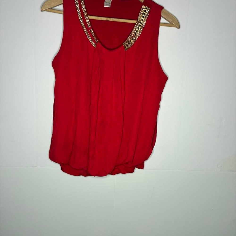 Red blouse with gold leopard print trim on the neckline